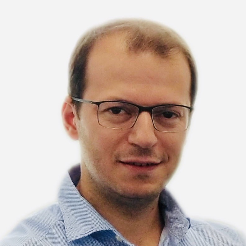 Head and shoulders photo of a man smiling at the camera