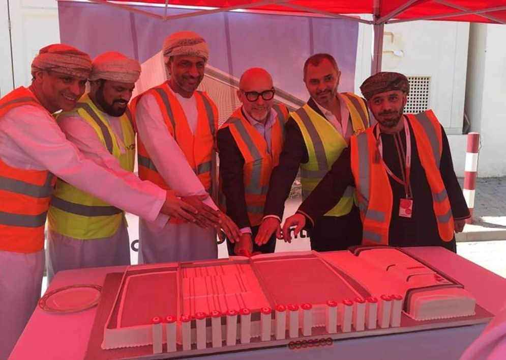 a small group photograph of a team wearing hi-vis jackets and hard hats