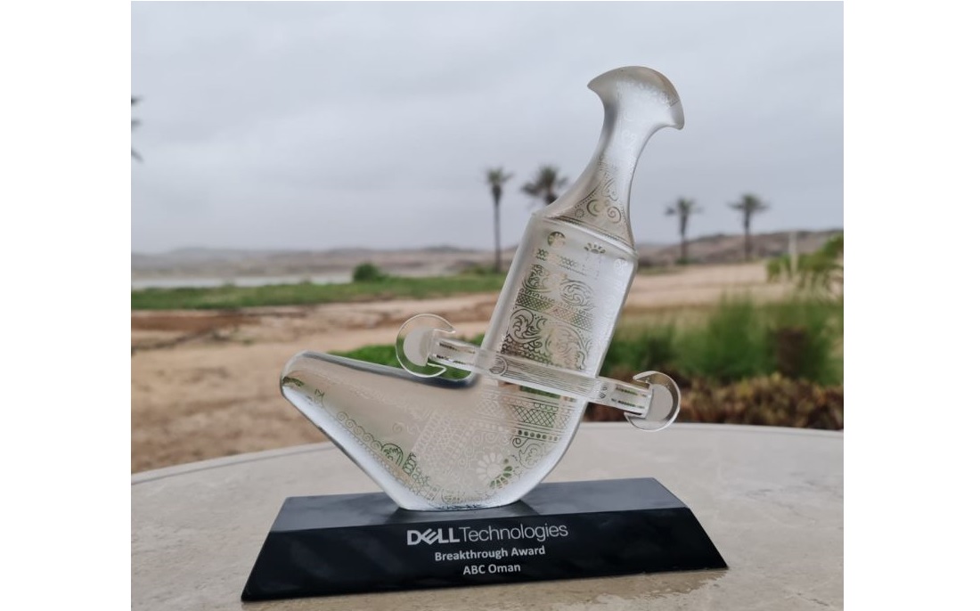 shows a glass trophy set on a plinth outdoors