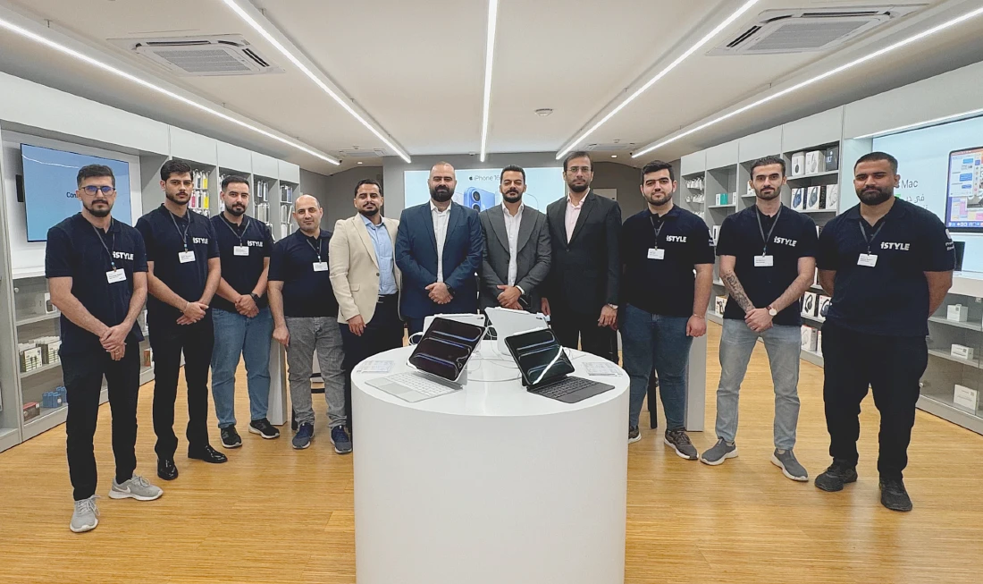 eleven men are seen in a team photo in a hi tech store