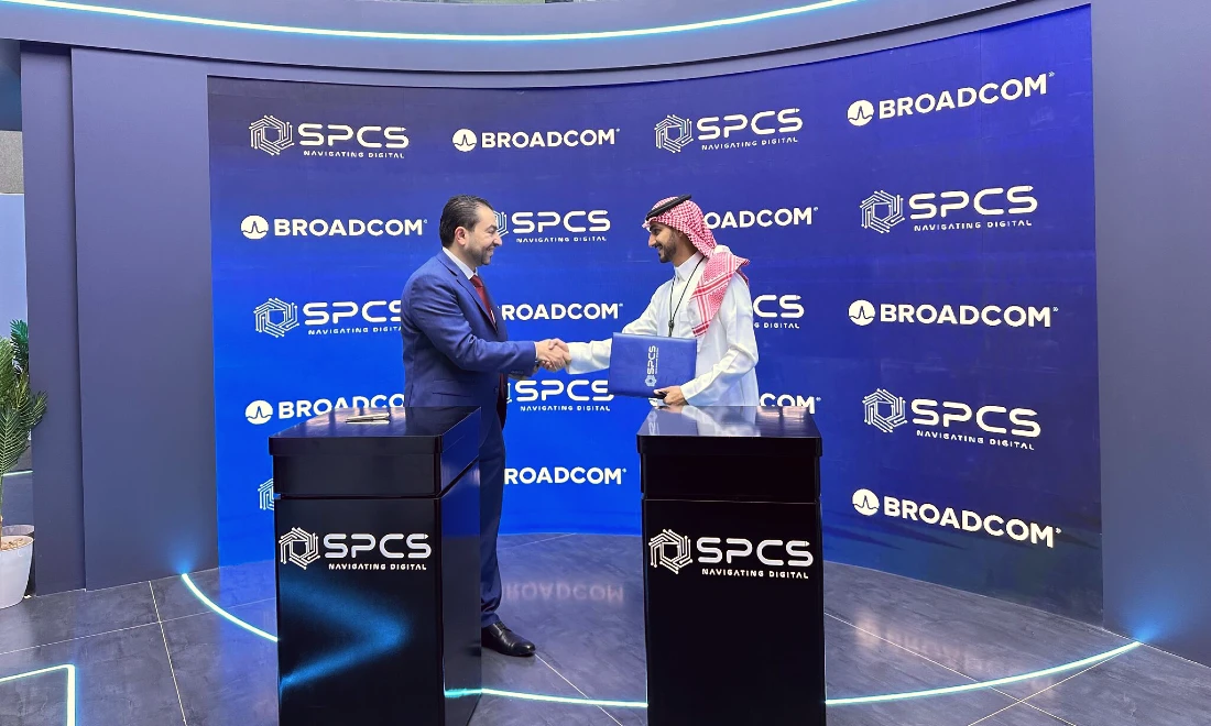 Two men are seen shaking hands after they have signed an agreement