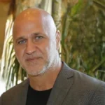 head and shoulders photo of a man in a suit jacket