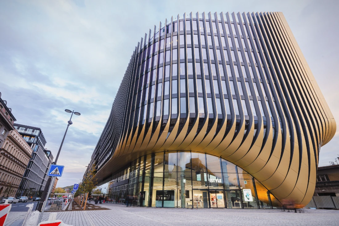 Exterior view of a very modern building with a hi tech retail site on the ground floor