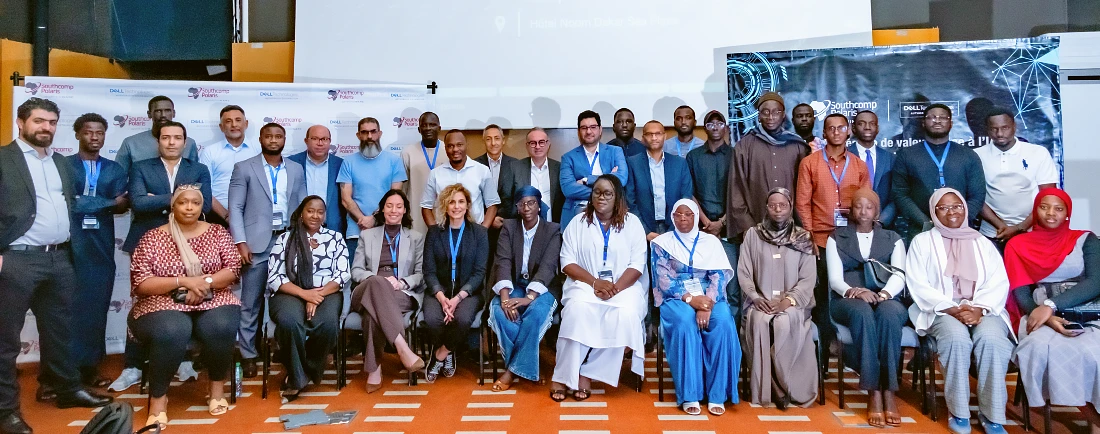 A large gathering of people in two rows are seen in a group photograph at a hi tech event