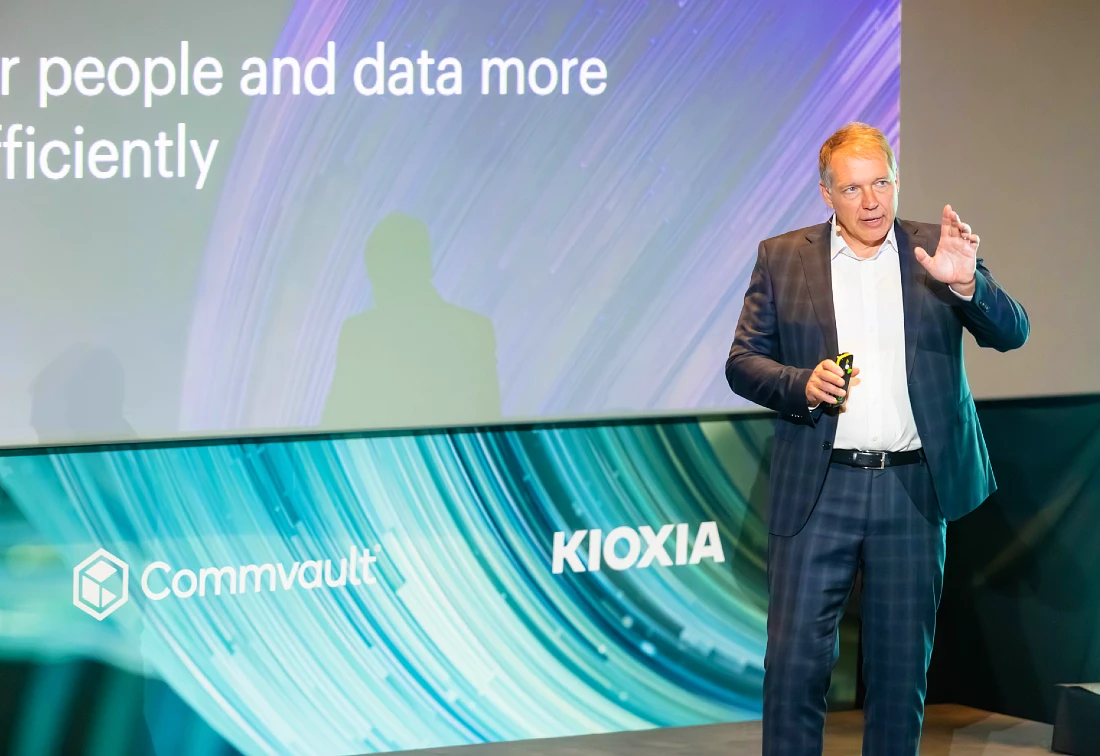 A man in a suit presents at a hi tech event